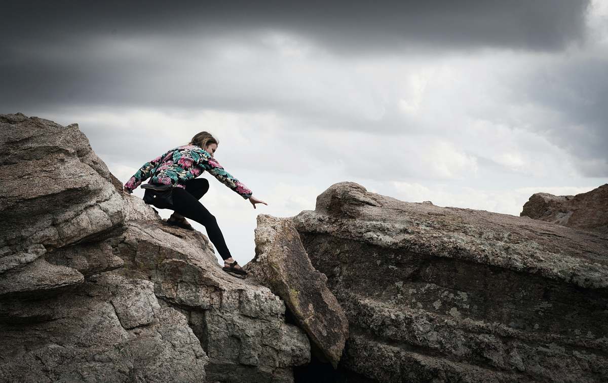 woman woman climbing on rocks during daytime photography coronado national forest